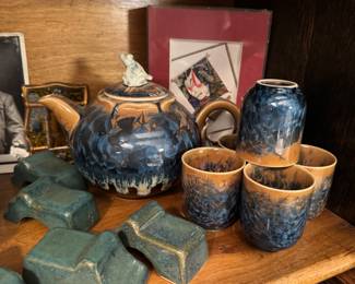 Japanese ceramic tea set features a teapot and multiple cups adorned with a distinctive blue and amber crystalline glaze, likely in the style of Kutani ware. 