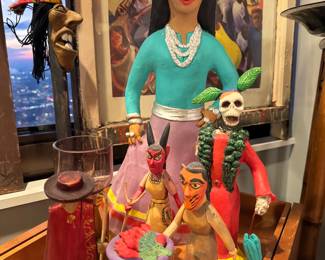 Mexican folk art figurines, featuring a prominent, elegant figure known as La Catrina Lamp