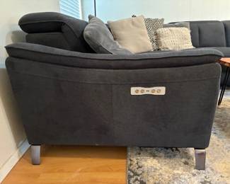 Power reclining sectional sofa with a built-in control panel
