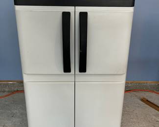 L27 - $20. Plastic 2 Door Garage Storage Cabinet. Approximately 2' tall.