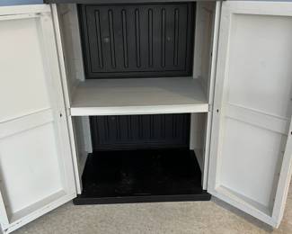 L27 - $20. Plastic 2 Door Garage Storage Cabinet. Approximately 2' tall.