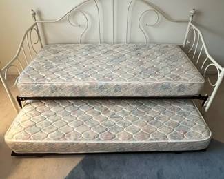 H1 - $150. Twin Size Trundle Bed. Iron Frame with brass accents. Includes linens and 2 clean twin mattresses if you'd like them! Measures 82.5" x 41" x 43" tall.