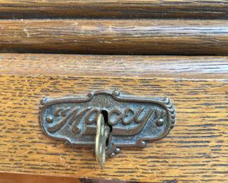 Detail—roll-top maker’s tag with key