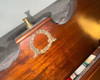 Gilded finial and carved laurel wreath