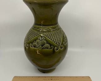 K7 - $35. Vintage olive green vase. Signed. Signed Anna Grandina. Chips on the base. Measures 7”w x 7”d x 10”t.