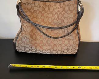 K2 - $45. Coach Signature Phoebe Canvas shoulder bag, in brown/tan. Like new condition. Measures 12”w x 6”d x 10”t.