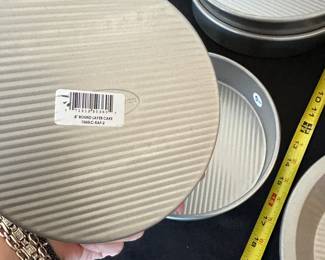 S42 - $50. Lot of 2 - 8" round layer cake pans, 2 - 10" Pie Plates. 2 - Bread Pans, 2 - 9.5" round pans, 1 8" x 8" pan.