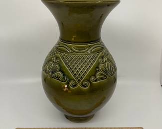 K7 - $35. Vintage olive green vase. Signed. Signed Anna Grandina. Chips on the base. Measures 7”w x 7”d x 10”t.
