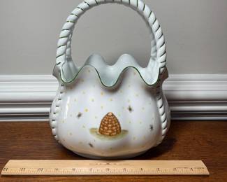 K44 - $35. Signed Handpainted USA ceramic basket with bees and honey motif. Measures 7”w x 5”d x 10”t.