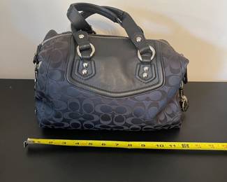 K4 - $45. Coach Ashley Signature black canvas handbag with leather trim, in black. Excellent condition. Measures 11.5”w x 4.5”d x 7”t.