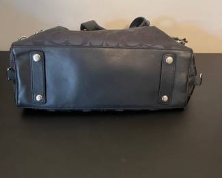 K4 - $45. Coach Ashley Signature black canvas handbag with leather trim, in black. Excellent condition. Measures 11.5”w x 4.5”d x 7”t.