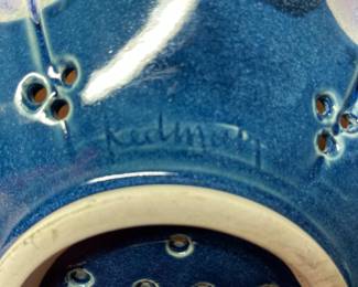 K31 - 25. Studio pottery flower shaped shallow bowl with holes. Decorative colander or fruit bowl. Signed Redman. Nancy Redman, local NC potter. Measures 11”w x 11”d.