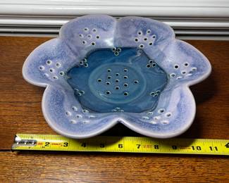 K31 - 25. Studio pottery flower shaped shallow bowl with holes. Decorative colander or fruit bowl. Signed Redman. Nancy Redman, local NC potter. Measures 11”w x 11”d.