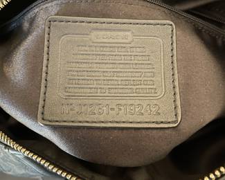 K4 - $45. Coach Ashley Signature black canvas handbag with leather trim, in black. Excellent condition. Measures 11.5”w x 4.5”d x 7”t.