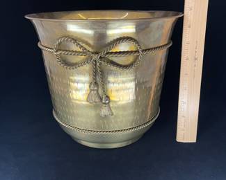 K23 - $20. Brass bucket/planter with brass bow decoration. Measures 8” wide x 8.5” tall.