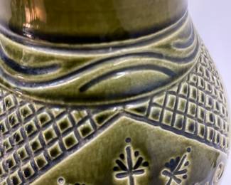 K7 - $35. Vintage olive green vase. Signed. Signed Anna Grandina. Chips on the base. Measures 7”w x 7”d x 10”t.
