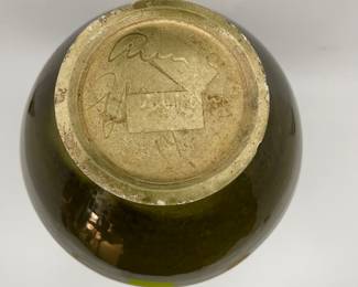 K7 - $35. Vintage olive green vase. Signed. Signed Anna Grandina. Chips on the base. Measures 7”w x 7”d x 10”t.