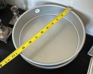 S42 - $50. Lot of 2 - 8" round layer cake pans, 2 - 10" Pie Plates. 2 - Bread Pans, 2 - 9.5" round pans, 1 8" x 8" pan.