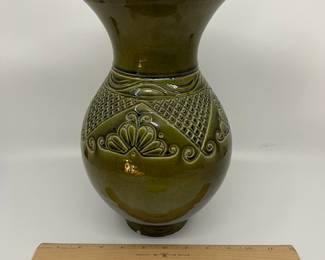 K7 - $35. Vintage olive green vase. Signed. Signed Anna Grandina. Chips on the base. Measures 7”w x 7”d x 10”t.