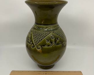 K7 - $35. Vintage olive green vase. Signed. Signed Anna Grandina. Chips on the base. Measures 7”w x 7”d x 10”t.