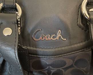 K4 - $45. Coach Ashley Signature black canvas handbag with leather trim, in black. Excellent condition. Measures 11.5”w x 4.5”d x 7”t.