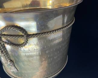 K23 - $20. Brass bucket/planter with brass bow decoration. Measures 8” wide x 8.5” tall.