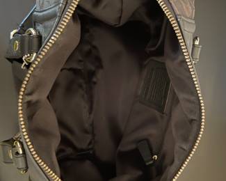 K4 - $45. Coach Ashley Signature black canvas handbag with leather trim, in black. Excellent condition. Measures 11.5”w x 4.5”d x 7”t.