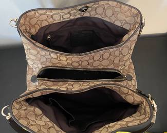 K2 - $45. Coach Signature Phoebe Canvas shoulder bag, in brown/tan. Like new condition. Measures 12”w x 6”d x 10”t.