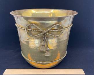 K23 - $20. Brass bucket/planter with brass bow decoration. Measures 8” wide x 8.5” tall.