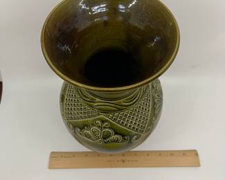 K7 - $35. Vintage olive green vase. Signed. Signed Anna Grandina. Chips on the base. Measures 7”w x 7”d x 10”t.