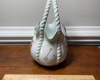 K44 - $35. Signed Handpainted USA ceramic basket with bees and honey motif. Measures 7”w x 5”d x 10”t.