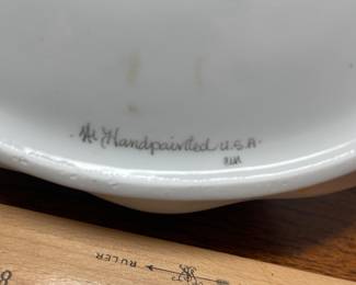 K44 - $35. Signed Handpainted USA ceramic basket with bees and honey motif. Measures 7”w x 5”d x 10”t.