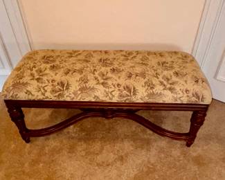 Upholstered bench with detailed wood legs