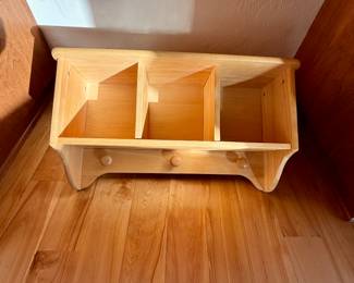 Wall shelf with cubbies and pegs for hanging