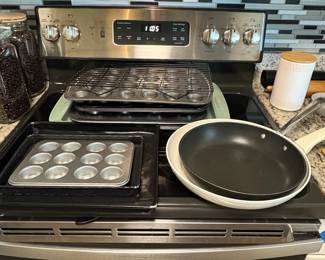 Assorted Kitchenware and Baking Supplies including Bamboo Organizer, Coffee Maker, Cast Iron Skillet, Le Creuset Pot, and Muffin Tins fourth image