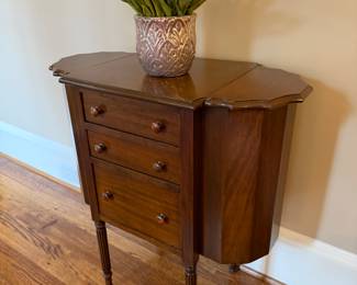 Antique sewing table that doubles as a unique place to store liquor. 