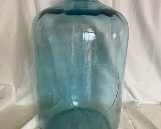  A large vintage blue-green glass carboy 
5-gallon jug originally used for water delivery