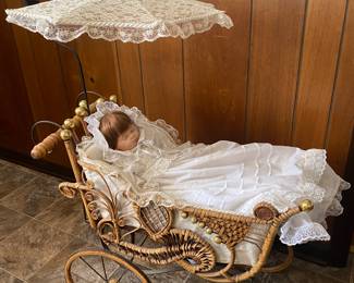 Baby doll in wicker buggie