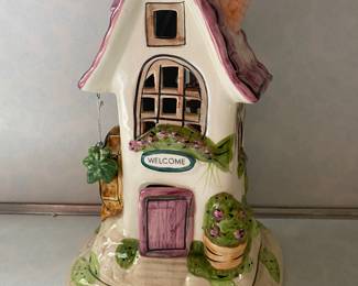 A hand-painted ceramic candle house by Blue Sky Clayworks, "Welcome Friends" collection