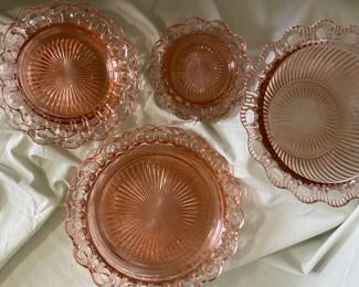  A collection of Anchor Hocking Old Colony pink depression glass dishes featuring a lace edge pattern. 
