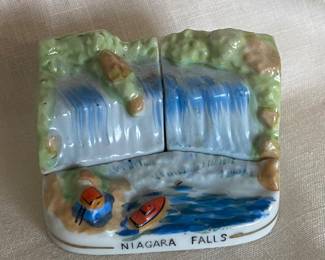 A vintage ceramic souvenir salt and pepper shaker set depicting Niagara Falls and the Maid of the Mist boat. 
