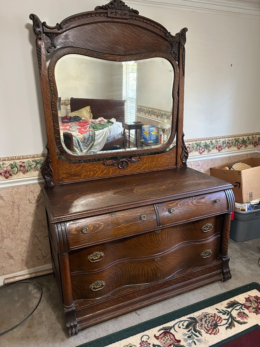 Antique Victorian Tiger Oak dresser with serpentine front and attached carved mirror . Location House 