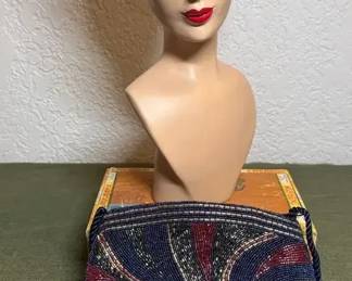 Mannequin head and beaded purse