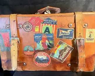 Vintage Leather Luggage With Weathered Travel Stickers