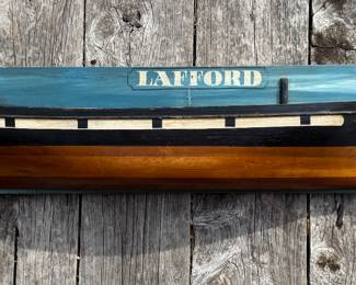 Capt. Scott “LAFFORD” 1876 – Nautical Folk Art Ship Plaque
Striking hand-crafted nautical wall sculpture featuring the hull profile of the vessel “LAFFORD” dated 1876, titled “Capt. Scott.” Mounted on a painted wooden backboard with a rich maritime blue ground.
The three-dimensional carved hull, painted in classic black, cream, and warm varnished tones, projects beautifully from the surface, giving it depth and presence. A wonderful coastal statement piece with strong New England maritime character.
Whether inspired by a historic schooner or created as commemorative nautical folk art, this piece captures the romance of 19th-century seafaring.
nautical wall art, ship plaque, maritime decor, folk art ship, carved wooden boat, coastal wall sculpture, schooner wall art, captain decor, vintage nautical, lake house decor, seaside art, maritime collectible, 1876 ship, seafaring decor, estate sale find