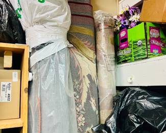 LOTS of rolled up area rugs of all sizes