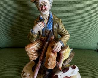 #15A - $75  - Capodimonte porcelain seated gamekeeper with his dog
