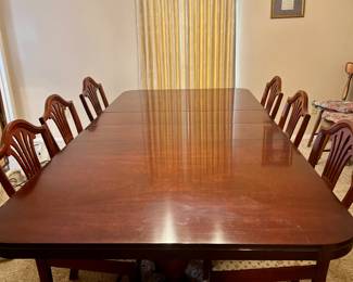 Drexel mahogany table, five chairs, plus captain's chair. Has been protected by custom pads.