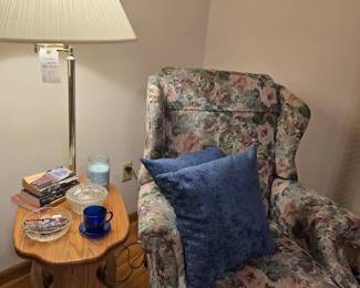 Nice floral recliner in the living room and floor lamp side table.