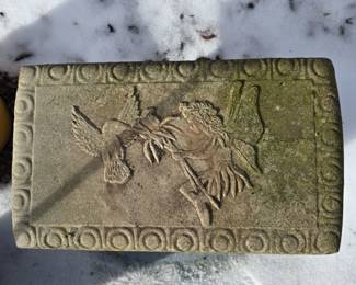 Small concrete bench in the backyard.